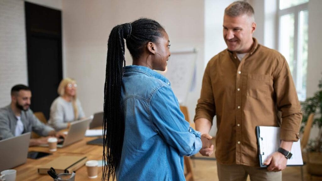Woman greeting her boss and asking questions like "Can you get fired for going to rehab?".