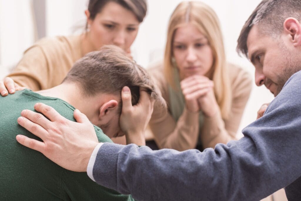 A man receives support from his family during outpatient rehab