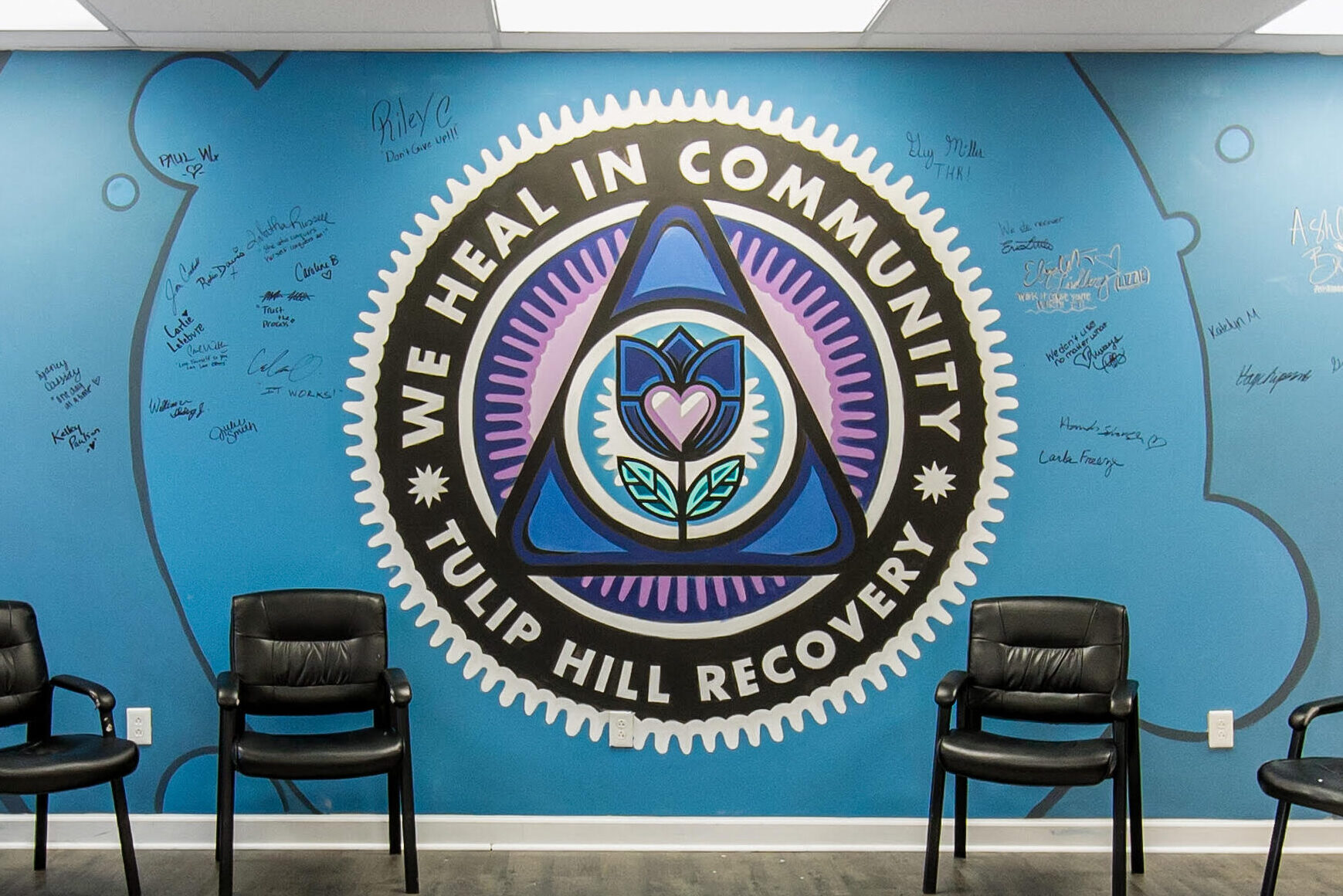 wall with logo and signatures at Tulip Hill Recovery