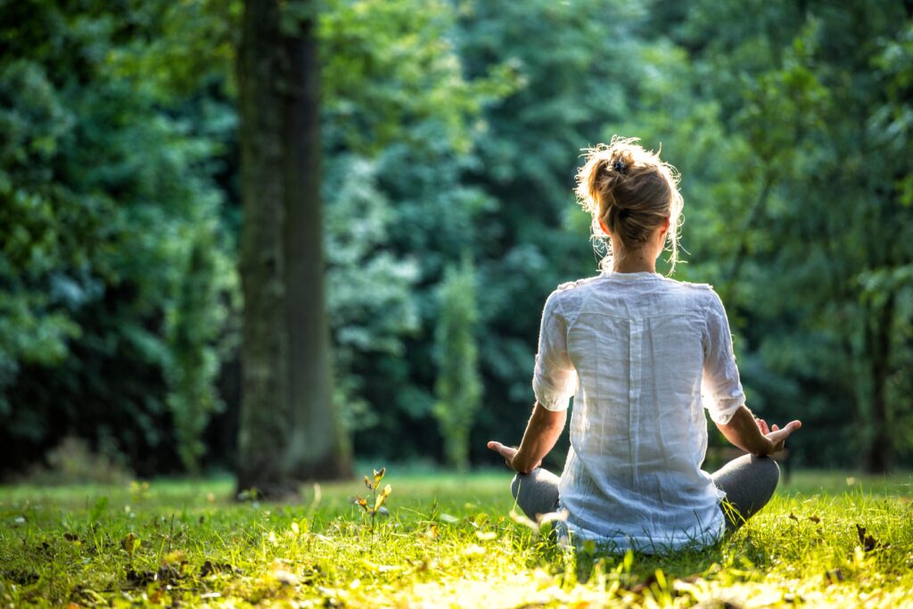 A woman enjoys holistic addiction treatment in Murfreesboro while meditating.