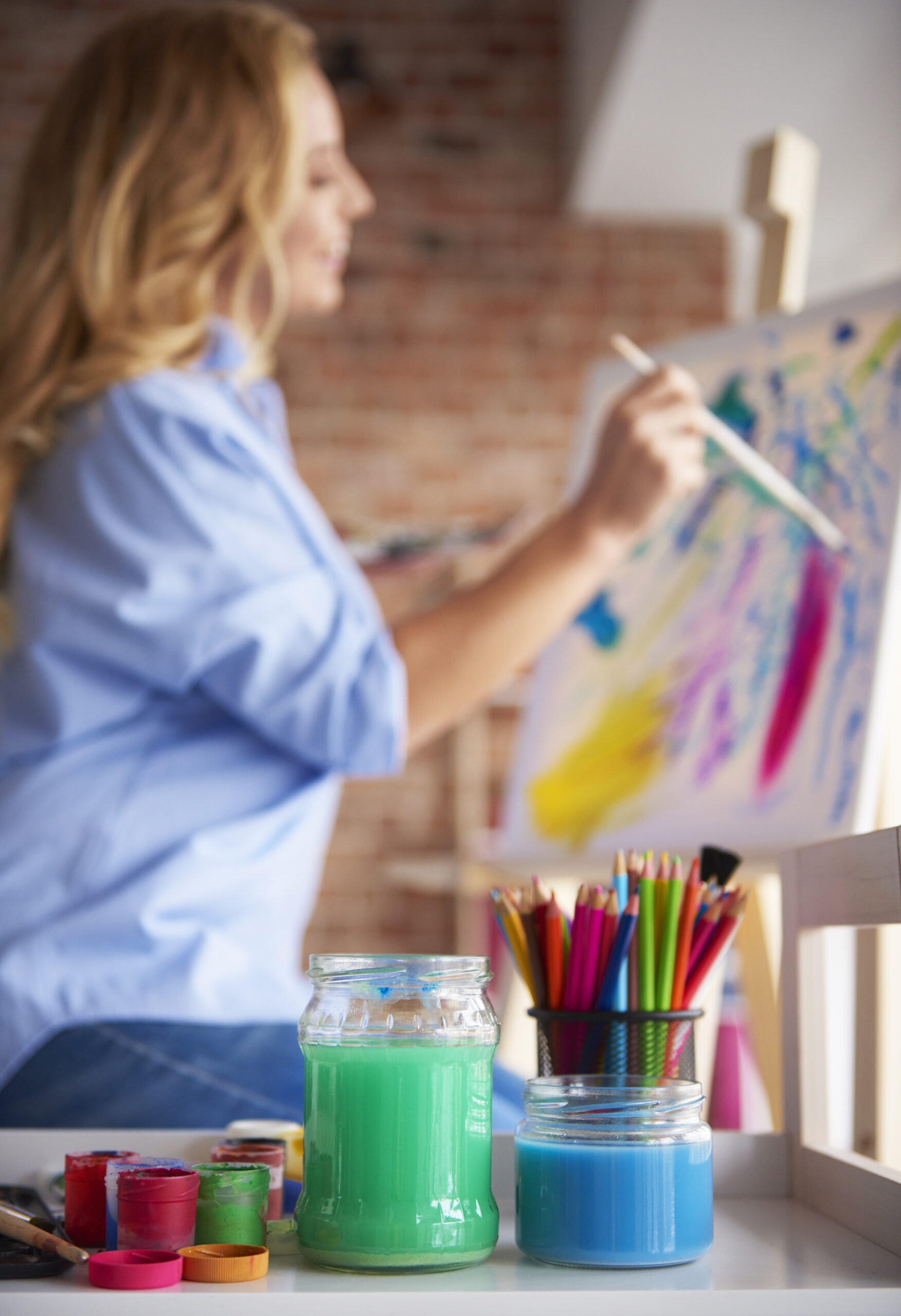 Woman painting during expressive art therapy for addiction and mental health recovery