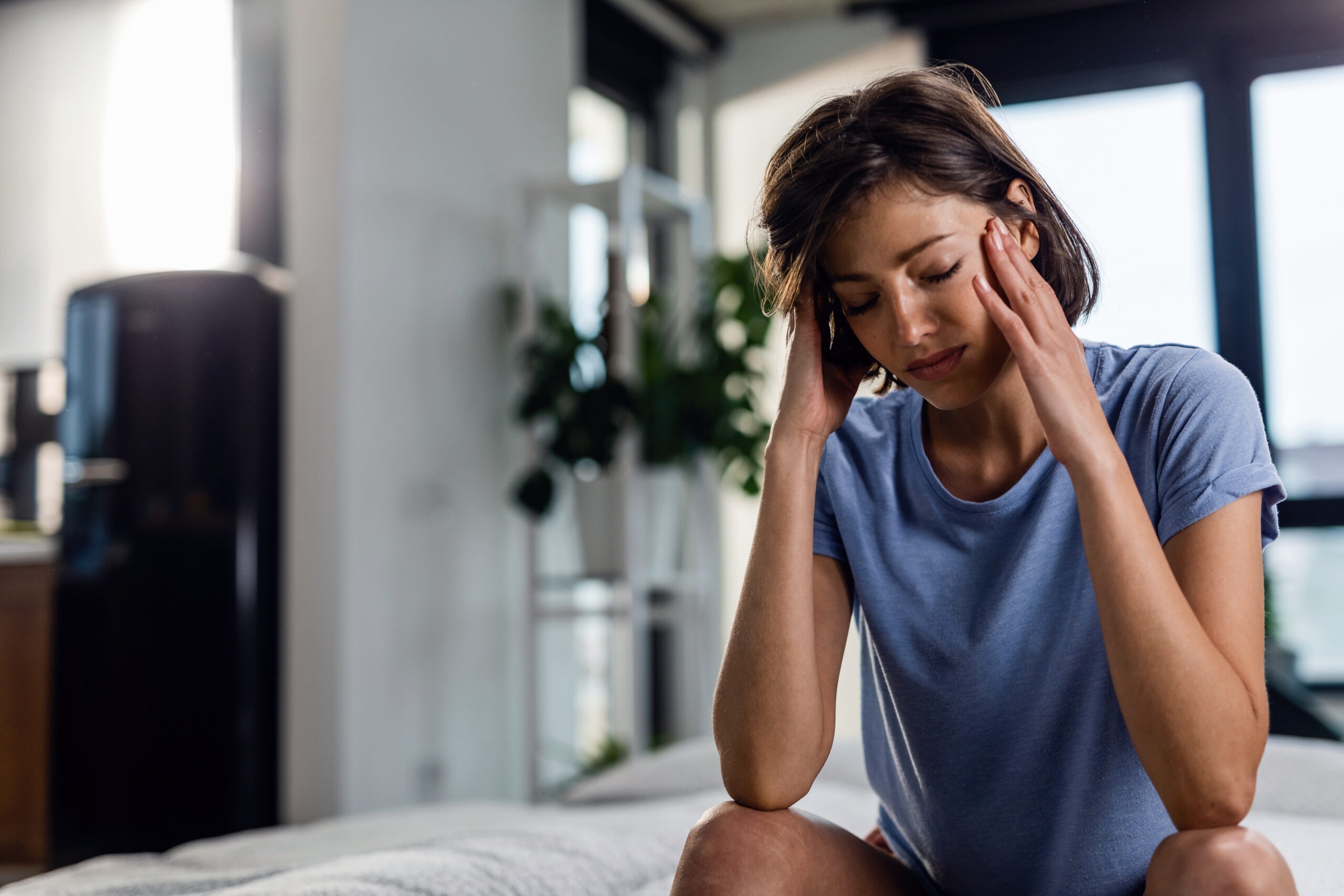 Woman experiencing headache and fatigue during stimulant withdrawal