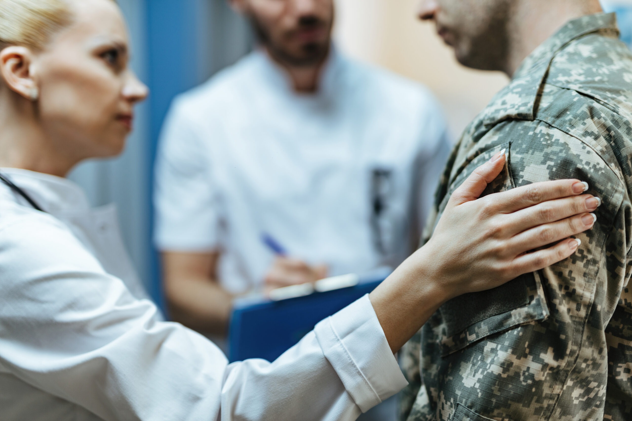 Healthcare professionals supporting a veteran during trauma treatment